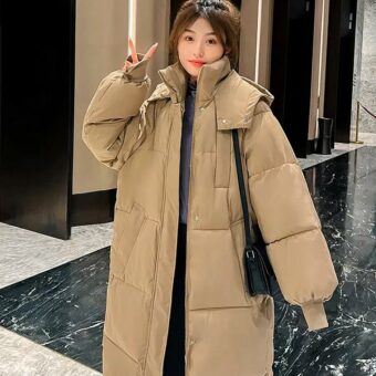 Photo d'une femme portant une longue doudoune camel dans un hall